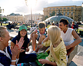 Teenage friends meeting up at Manege square, Moscow, Russia, Europe