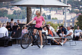 Woman cycling on an e-bike, bike tour, Waranga Bar, Schlossplatz, Museum of Arts, Stutttgart, Baden-Wurttemberg, Germany