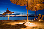 Illuminated sunshades at a beach bar, Njivice, Kvarner Gulf, Krk Island, Croatia, Europe