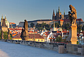 Statues on Charles bridge and view towards Prague castle, Prag, Czech Republic