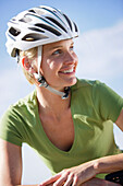 Woman wearing cycle helmet, Lake Starnberg, Bavaria, Germany