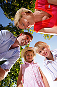 Family smiling at camera, Lake Starnberg, Bavaria, Germany