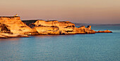 Limestone cliffs, east of Bonifacio and Sardinia on the horizon, Corsica, France