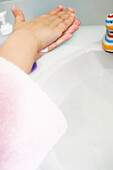 Little girl washing her hands, close-up