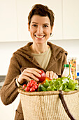 Portrait of a mid adult woman smiling in the kitchen