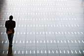 Man walking at airport, rear view