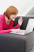 Young woman using a laptop and smiling
