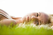 Young woman lying in the grass