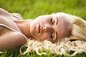 Young woman sleeping in the grass