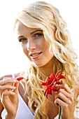 Young woman holding a red gerbera