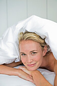 Close-up of a woman lying on the bed and smiling