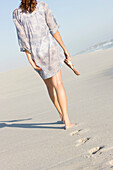 Rear view of a woman walking on the beach