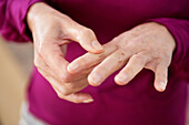 Close-up of a woman suffering from finger pain