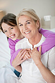 Portrait of a girl hugging her grandmother