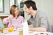Man eating breakfast with his daughter