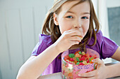 Portrait of a girl eating gum drops