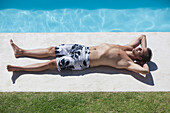 Man sunbathing at poolside
