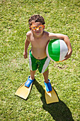 High angle view of a boy holding a beach ball