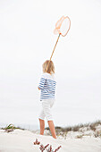 Rear view of a girl holding net