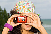 Woman taking a picture with a digital camera