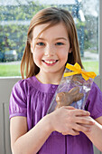 Portrait of a girl holding an Easter bunny and smiling