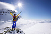 Mountaineer at the summit of Jungfraujoch, Jungfrau in the background, Grindelwald, Bernese Oberland, Switzerland
