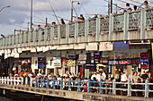 Fish restaurants and aglers on Galata bridge at Golden Horn, Istanbul, Turkey, Europe