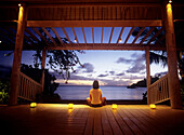 Woman contemplating sunset, Indigo on the Beach, Carlisle Bay Hotel, Antigua