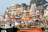 Hindu pilgrims and boats at River Ganges, Varanasi, India