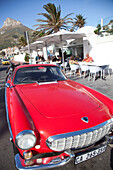 'Bright, cool cars parked in Camp's Bay, Cape Town, South Africa'13;&#10;'