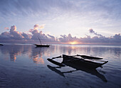 Dhows in calm waters at low tide at dawn, Matemwe beach, Zanzibar, Tanzania
