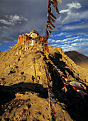 Leh Monastery and prayer flags at dusk, Ladakh, India