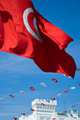 Tunisia flag, and government building in back ground, Tunis, Tunisia