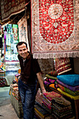 Carpet and rug vendor in the Kapali Carsi / Grand Bazaar in Beyazit, Istanbul Turkey