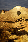 Hot air Balloons shadow over mountains, Cappadocia, Turkey