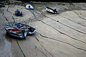 Fishing boats at low tide at St. Ives harbor, Cornwall, England, UK