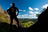 Silhouette of walker looking along Langdale from near Chapel Stile, Lake District, Cumbria, UK.
