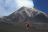 Italy, Sicily, woman walking on lavas under Etna volcano