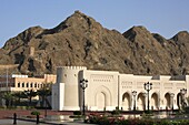Oman, Muscat, government buildings colonnade, mountain scenery