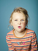 Portrait of little girl making a face