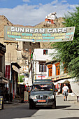 Street scene in Leh with monastery of Leh in background, Leh, valley of Indus, Ladakh, Jammu and Kashmir, India