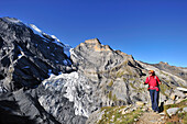 Woman ascending to Sefinenfurgge, Bluemisalp in background, UNESCO World Heritage Site Jungfrau-Aletsch protected area, Bernese Oberland, canton of Bern, Switzerland