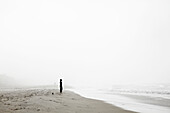 Lonely Woman Standing on Beach and Looking Out to Sea, San Diego, California, USA