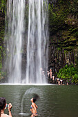 Young people bathing at Millaa Millaa Falls, Atherton Tablelands, Queensland, Australia