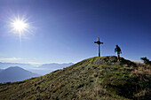 Hiker on the summit of Notkarspitz, Ammergau Alps, Upper Bavaria, Bavaria, Germany