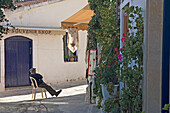 An old man sitting in a shaded street, Omodhos, Cyprus