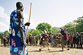 Mursi tribal man with donga dueling pole and tumoga dueling kit during thagine ceremonial dueling, Makki Village, South Omo, Ethiopia
