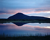 Lake Myvatn at sunset with mountains reflected in water, Reykjahlio, Lake Myvatn, Iceland