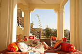 Woman relaxing on balcony, DEVI GARH HOTEL NEAR UDAIPUR, RAJASTHAN, INDIA