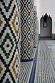 Mosaicked columns and floor in the courtyard of The Museum of Marrakesh, Marrakesh, Morocco